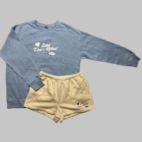a blue sweatshirt and shorts set with the words'love is in the air'