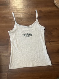 a white tank top with a green logo on it