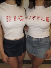 two women wearing t - shirts that say big little