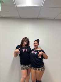 two women in leopard shorts posing for a picture